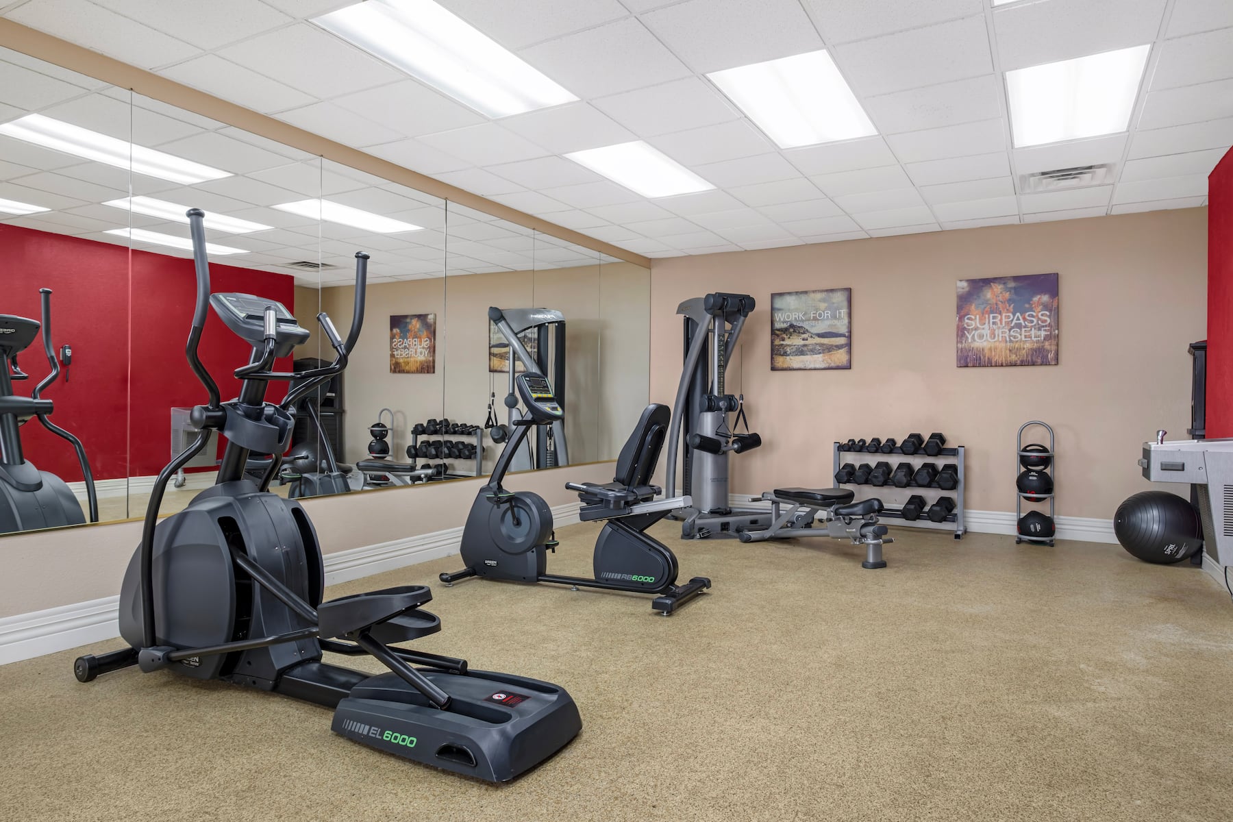 Hotel fitness center with strength equipment and free weights